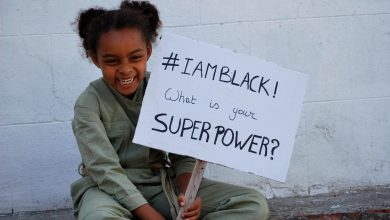 Black girl / mixed girl holding a board with slogan during black lives matter #blacklivesmatter
